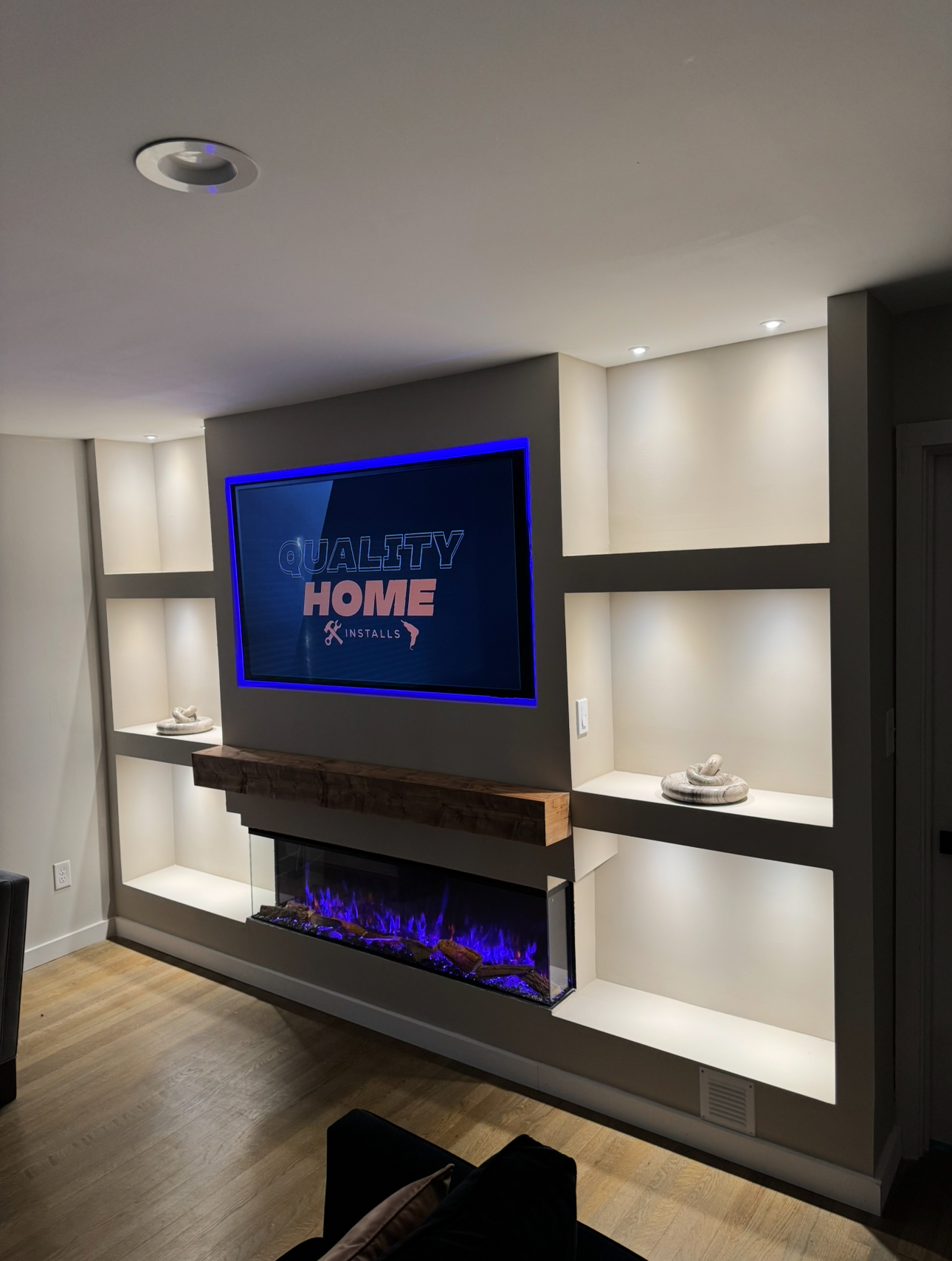 Modern media wall with floating wood mantle and recessed fireplace