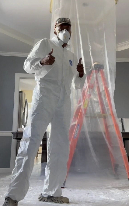 Jaquan Straughn on-site in protective suit during a build